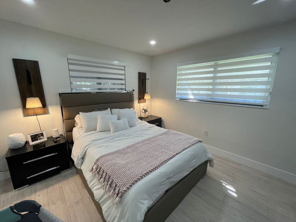 Modern bedroom with zebra blinds installed by Miami Best Blinds, window treatment experts in Miami.jpg