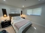 Modern bedroom with zebra blinds installed by Miami Best Blinds, window treatment experts in Miami.jpg